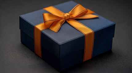 Obraz premium Dark Blue Gift Box with Orange Ribbon and Stationary