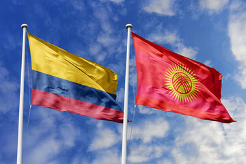 Colombia and Kyrgyzstan flags gracefully waving in the wind against a picturesque blue sky,...