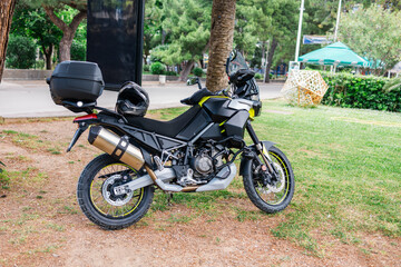 Adventure motorcycle parked on green roadside. Outdoor mobility, travel freedom, and motorbike touring equipment.