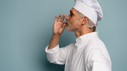 professional chef kisses his hands.
