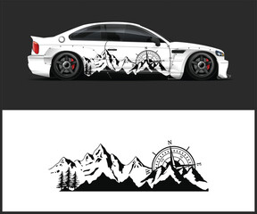 Modern white sports car adorned with a black mountain and compass graphic decal design © MdAbdullah
