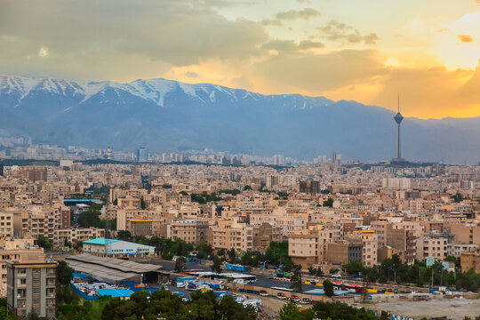 Beautiful cityscape sunset panorama of Tehran city, mountains and Milad tower in during colorful sunset in Iran - Powered by Adobe