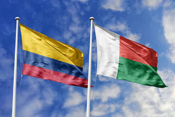 Colombian and Malagasy flags proudly wave together, symbolizing international relations, friendship, and cultural exchange.