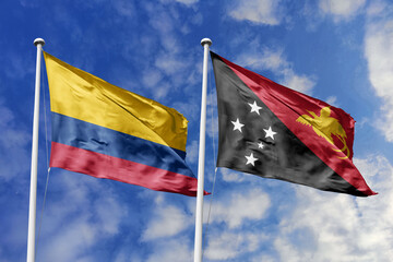 Waving flags of Colombia and Papua New Guinea against a vibrant blue sky, symbolizing international...