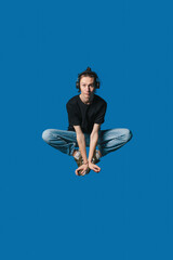 A meditation enthusiast depicted against a soothing blue background, embodying tranquility