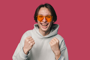 The Joyful Youth Wearing Stylish Orange Glasses Happily Celebrating a Fun Occasion