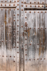Old wooden door with wrought iron details in Villanueva de los Infantes town
