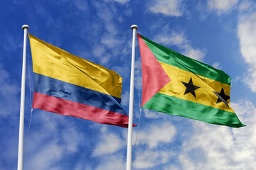 Waving flags of Colombia and Sao Tome and Principe against a vibrant blue sky, symbolizing international relations and friendship.