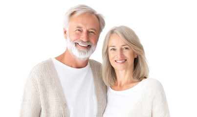 A joyful elderly couple smiling warmly at the camera. dressed in cozy sweaters. standing against a bright white background. conveying happiness and love in a serene home setting
