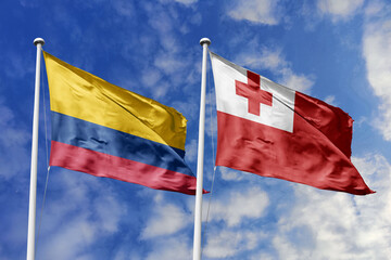 The Vibrant Flags of Colombia and Tonga Waving Together in the Breeze Under a Bright Blue Sky,...