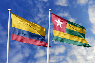 The Vibrant National Flags of Colombia and Togo Waving Proudly Together Under a Bright Blue Sky, Symbolizing Growing Diplomatic Ties and a Bridge Between Diverse Continents and Cultures.