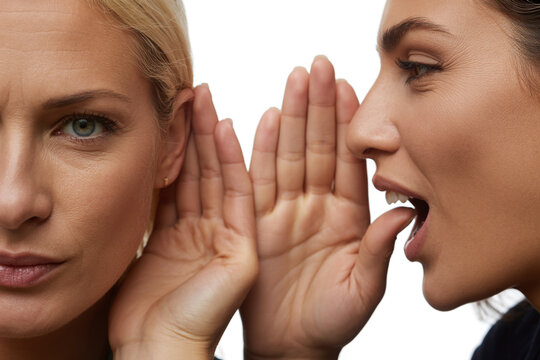 Woman whispering a secret into another womans ear