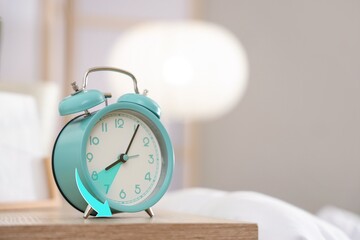 Alarm clock on table in bedroom. Fall back concept
