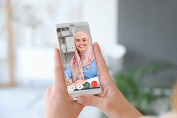 Woman using application of smart home automation