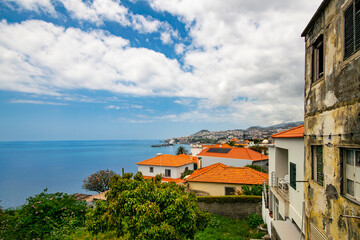 Distant view of Funchal besides dilapidated house