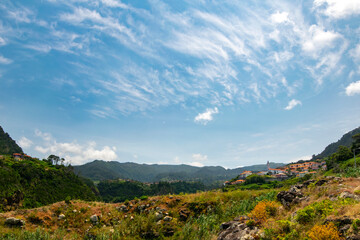 Obraz premium Small village in the mountains with blue sky in Madeira