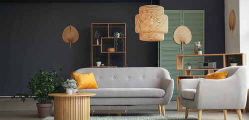 Interior of modern living room with grey sofa, armchair and wooden coffee table