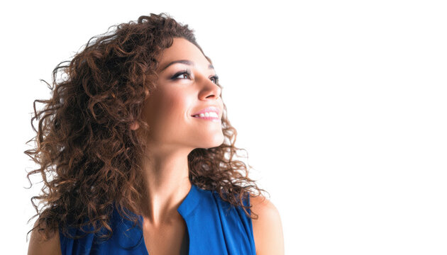 A young woman with curly hair wearing a blue top smiles while looking up. set against a plain white background. conveying a sense of positivity and hopefulness