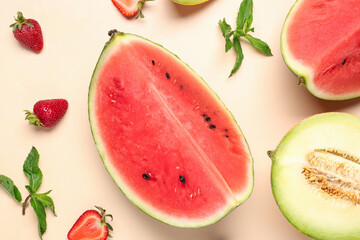 Pieces of fresh watermelon and different berries on orange background