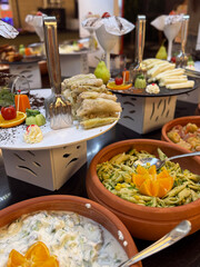 Traditional Turkish meal with dolma and greens on buffet plate. Large serving plate with dolma, fresh greens and vegetable sides at hotel buffet in Turkey