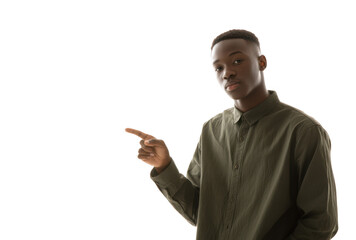 A young man in a green button-up shirt confidently points to the left against a bright white background. suggesting an invitation or announcement. ideal for marketing or promotional use