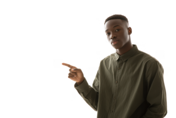 A young man in a green button-up shirt confidently points to the left against a bright white background. suggesting an invitation or announcement. ideal for marketing or promotional use