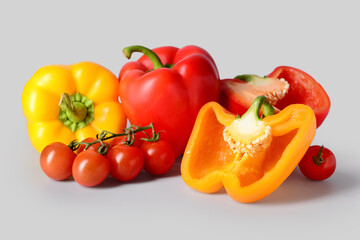 Fresh peppers and tomatoes on grey background
