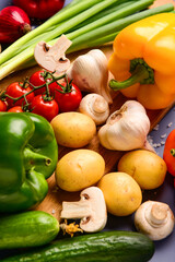 Fresh vegetables and mushrooms on blue background