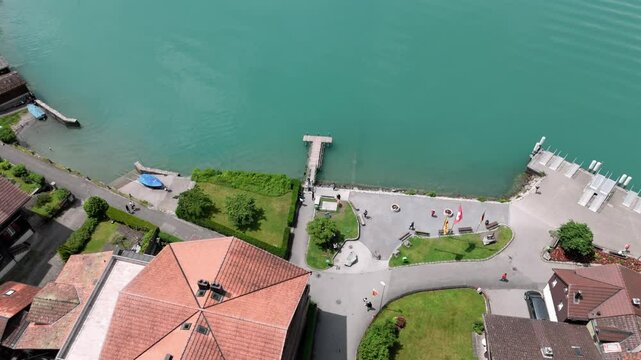 Flying over the famous pier film location of Crash Landing on you revealing the stunning view of the turquoise lake Brienzersee surrounded by the alp mountains near Interlaken Switzerland europe