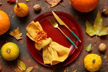 Beautiful table setting for Thanksgiving Day celebration on grunge brown background