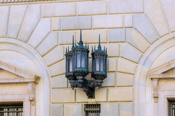 Vintage street lamp adorns wall of historical building, illustrating beautiful architectural design...