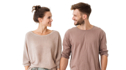 A couple smiling at each other while holding hands, dressed casually, isolated on white background.