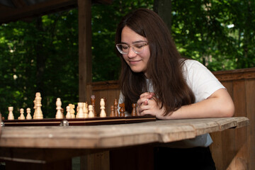 Young woman is playing chess	