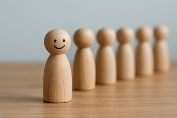 Smiling wooden figurine stands out from the crowd, symbolizing leadership, individuality, and positive team dynamics against a simple, light background.
