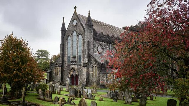 St. Canice's Cathedral in Kilkenny, Ireland, surrounded by ancient graveyard and autumn trees