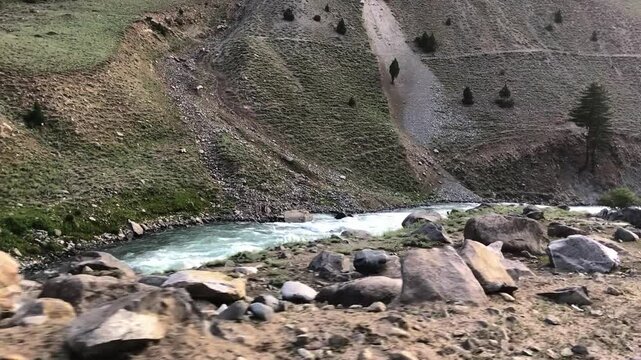 Crystal-clear blue waters of the Indus River flow from Himalayan peaks along the road from Astore to Skardu, Pakistan. Fed by snow, this pristine river runs year-round through majestic landscapes.	