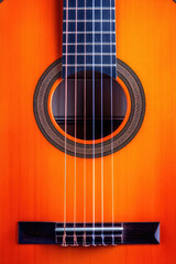 Obraz premium Acoustic guitar shown close-up with strings and soundhole in focus. Musical instrument, music, stringed, acoustic