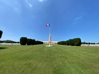 View of the Douaumont Ossuary from the military cemetery in Verdun, France, under a clear sky, commemorating World War I soldiers