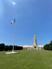 View of the Douaumont Ossuary from the military cemetery in Verdun, France, under a clear sky, commemorating World War I soldiers