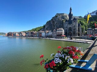 Scenic view of Dinant, Belgium, from the bridge on a sunny day, with the Collegiate Church of Notre-Dame and the citadel in the background