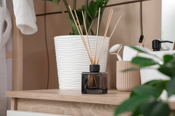 Natural reed diffuser on table in bathroom