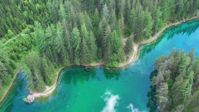 Aerial of alpine paradise emerald lake Gruner See with crystalline waters and pine forest. Summertime in Austria.
