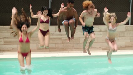 Group of young adults enjoying summer vacation, jumping and playing inside a swimming pool - Powered by Adobe