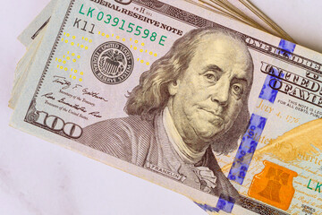 Stunning arrangement of hundred dollar bills on marble surface highlighting unique features of US...