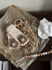 Socks with medals, white scratches, a rodent elephant and baby beads on parchment paper are on the...