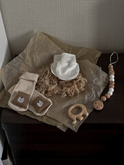 Socks with medals, white scratches, a rodent elephant and baby beads on parchment paper are on the...