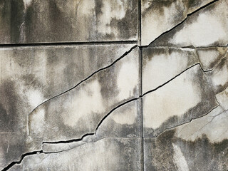Many structural diagonal cracks on cement wall or textured. caused by the earthquake.