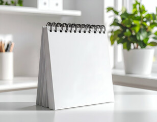 Blank desktop calendar mockup standing on white table