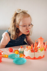 Girl with Down syndrome plays with toys