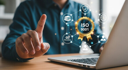 Person interacting with iso 9001 quality management system on laptop